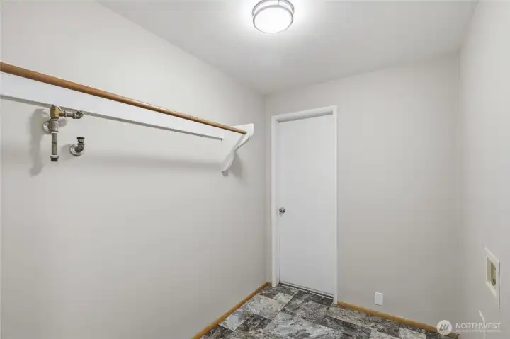 Versatile utility room offering additional storage, laundry functionality, and flexible space for a mudroom, pantry overflow, or household organization. Conveniently located with easy access to the main living areas.