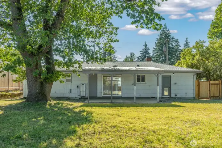 Covered patio and oversized backyard provide the perfect setting for outdoor dining, summer gatherings, gardening, and year-round enjoyment.