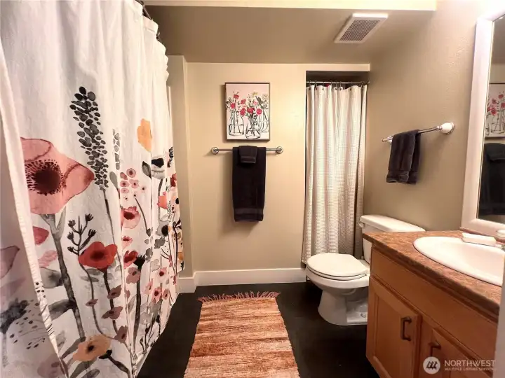 Full bathroom with storage closet Full bathroom with storage closet