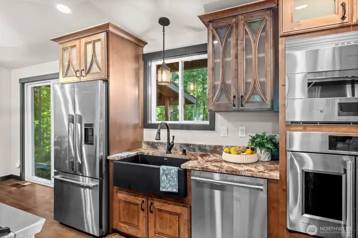 Beyond the striking design and warm textures, this kitchen features an impressive wall of cabinetry offering exceptional storage solutions. Beyond the striking design and warm textures, this kitchen features an impressive wall of cabinetry offering exceptional storage solutions.