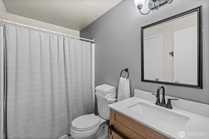 From the bright vanity to the thoughtful finishes, this full bath delivers a flawless blend of modern utility and peaceful warmth, creating a space that feels both highly functional and deeply inviting. From the bright vanity to the thoughtful finishes, this full bath delivers a flawless blend of modern utility and peaceful warmth, creating a space that feels both highly functional and deeply inviting.