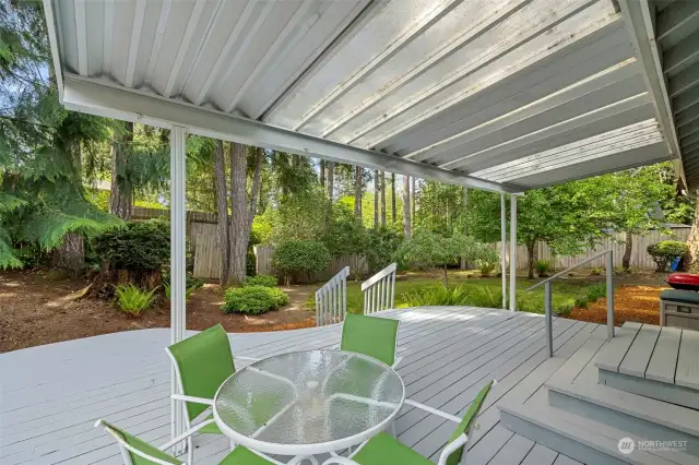 Imagine entertaining or just relaxing on this wonderful deck. This picture also shows the lush low maintenance backyard.