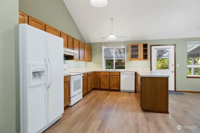 You will love preparing culinary delights in this wonderful kitchen, you will love all the counter and cabinet space. The door on the right opens to a spacious covered deck you cal enjoy year around.