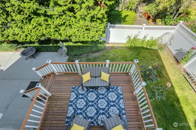 Covered upper deck overlooks the lovely yard and offers some peek-a-boo Sound and mountain views.