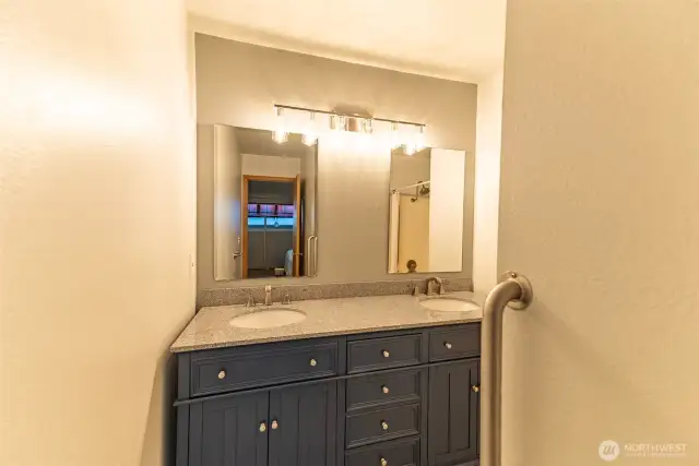 Ensuite bath to primary bedroom with granite counter