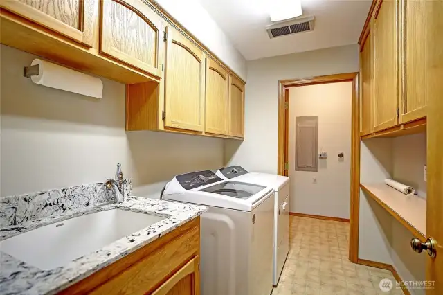 Large laundry room with utility sink.
