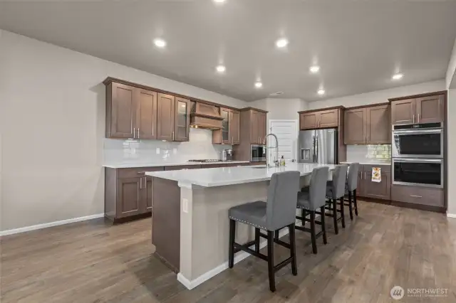 Large island, gas stove, double ovens and premium finishes.