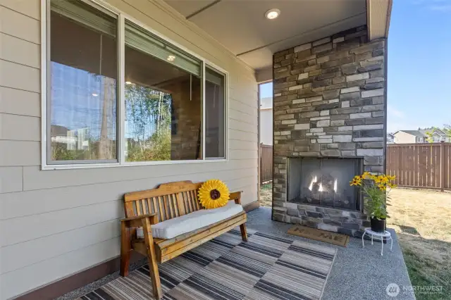 Cozy Outdoor Living! Covered patio with a gas fireplace—perfect for year-round enjoyment.