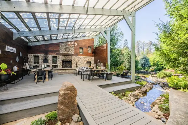 A bridge over the water feature as a transition between the outdoor covered living spaces.
