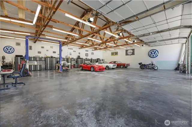 Building #3:  Size: 3600 sqft shop, 1200 DADU #1, 1200 DADU #2, = 6000 Square Feet Total  Fully insulated building.  Power: 200 amp, with space for more power, plus two 50A / 30A RV connections,  Two post hydraulic car lift,  Six total 10x12 powered garage bay doors,  New Workbenches & cabinets,  Cat5 Wired with WIFI,  Additional storage room with industrial 8’ shelving & separate bay door (this bay is not shown in the photos)  50’ deep covered storage space for grounds maintenance equipment,  Air compressor with 50A connection