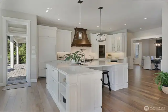 Chefs kitchen:  Custom cabinets, including pull-outs, organizers, soft-close hinges, solid iron hardware, under cabinet lighting.  Under counter Kangen water system,  Restoration Hardware Lighting,  Quartz counters with custom edge detail,  Walk-in pantry w/ coffee bar,  Custom cabinet-matched Sub-Zero commercial refrigerator,  Wolf Warming Drawer w/serving containers,  Built-in cabinet matching Sub Zero Wine Fridge with Cold Beverage Drawers,  48” Viking Gas Range w/ double ovens & skillet,  Pot filler,  Custom Range hood