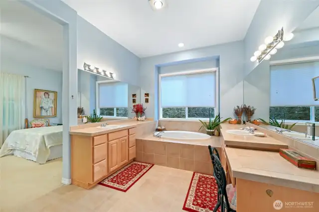 Primary bath with separate vanities and a soaking tub.
