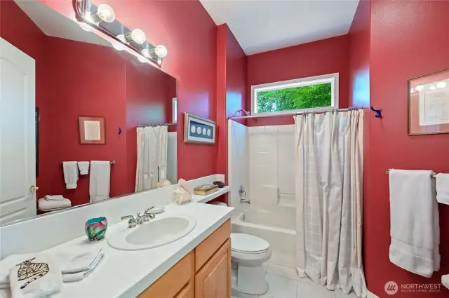 The full bath is adjacent to the third bedroom.