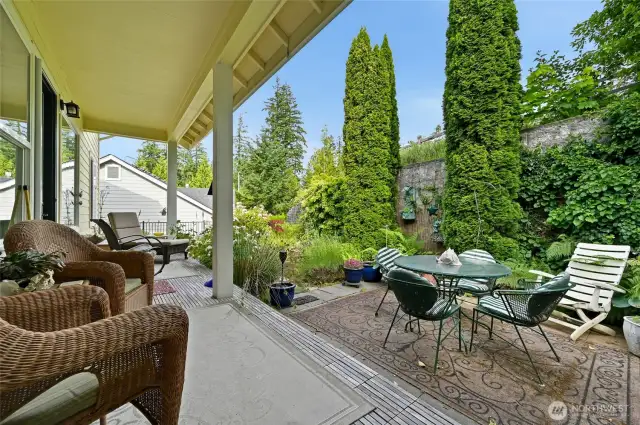 Enjoy the backyard year-round on the covered deck and large paver patio. Nice garden area to the left.