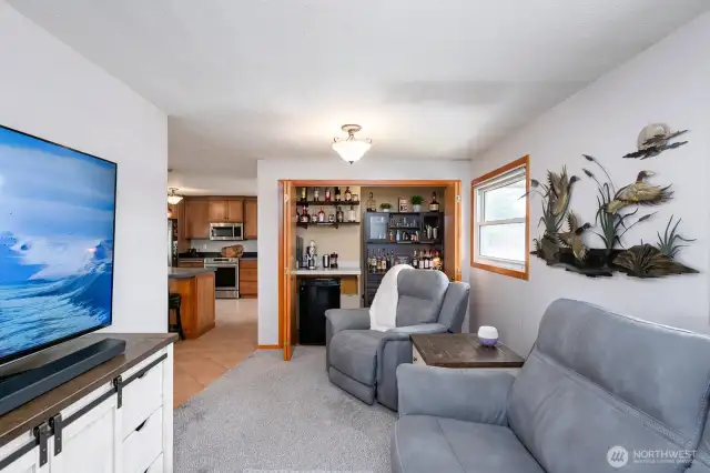 Just off the kitchen is a TV/Study with discrete private bar.