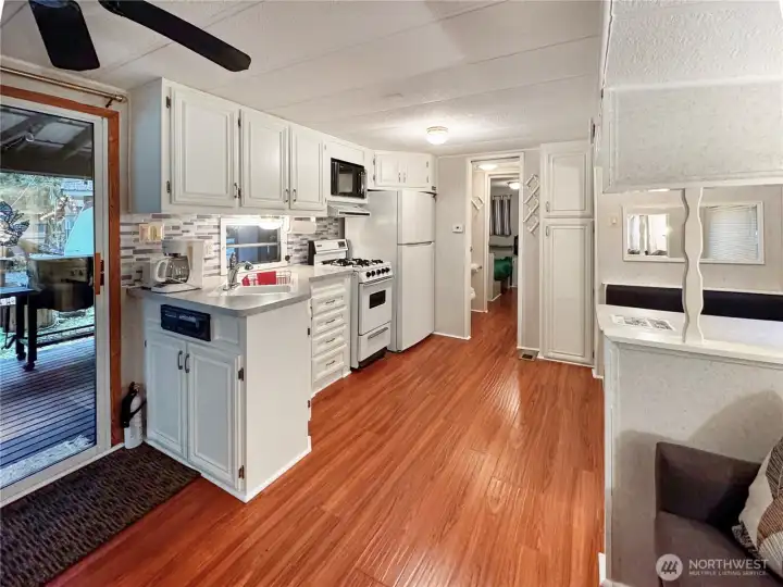 Open and updated kitchen, living, and dining space with full size fridge.