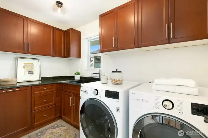 The upstairs laundry room (plus two additional full baths) completes the upstairs. Look at that storage! Washer and Dryer are almost new.