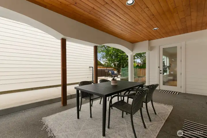 Upon exiting the kitchen, you can walk through the covered patio to the yard, or to the garage.