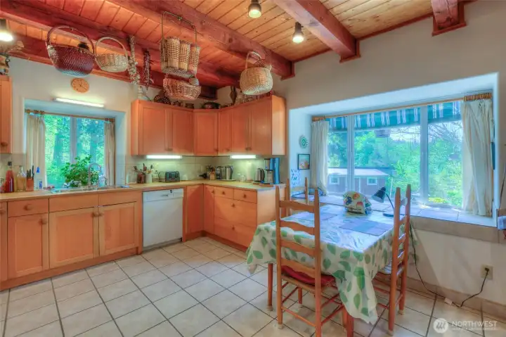 Views from the kitchen include draping grape vines, orchard trees and birds playing in the bird bath.