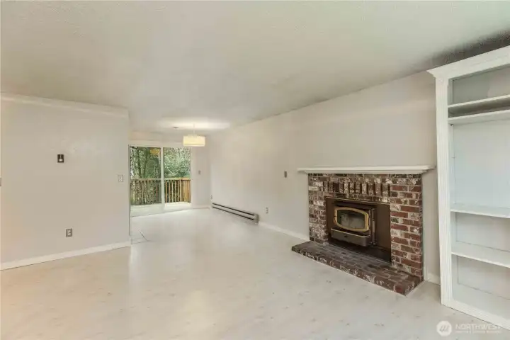 Living room looking to dining area and slider to large deck