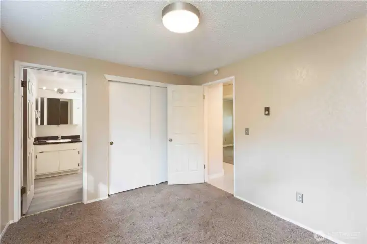 Primary bedroom looking to full bathroom
