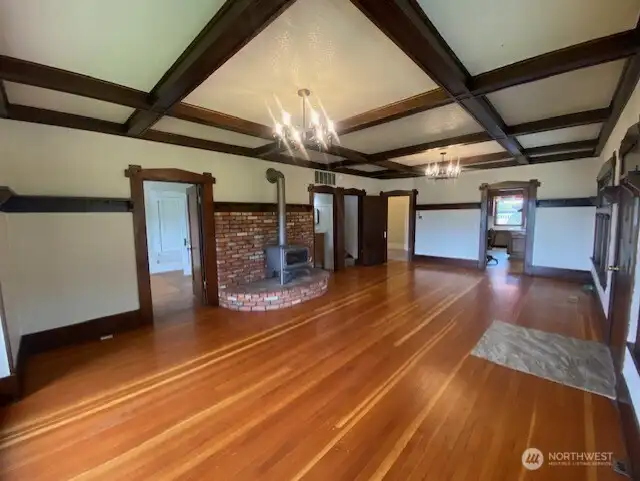 Large family room with lovely wood floors.