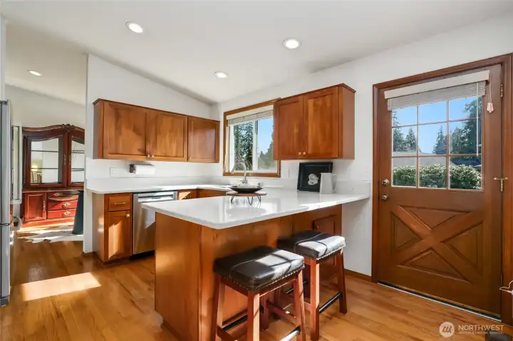 Quartz counter tops and cherry cabinets.