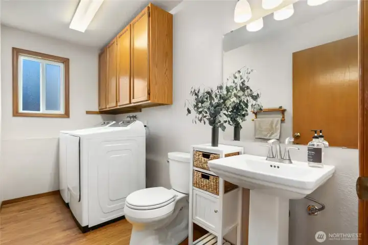 Lower level laundry with half bathroom.