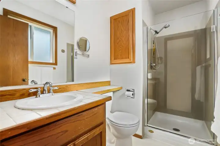 Primary ensuite bathroom on upper level.