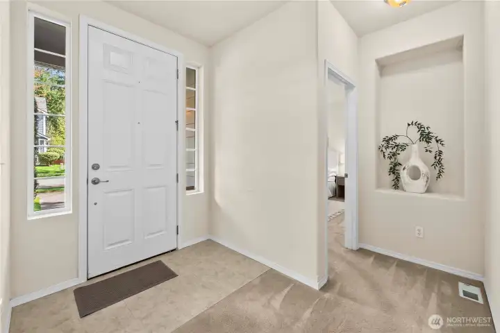 Enter through the 8' tall front door to a bright and generously-sized entry hall.