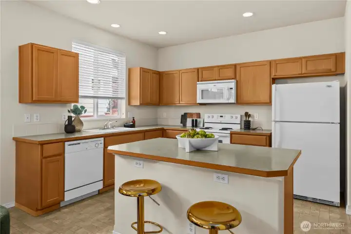 The kitchen is appoointed with a center island that features bar seating.