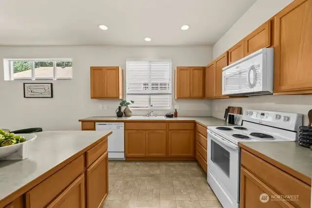 The kitchen offers plenty of cabinet and counter space and has all appliances included.
