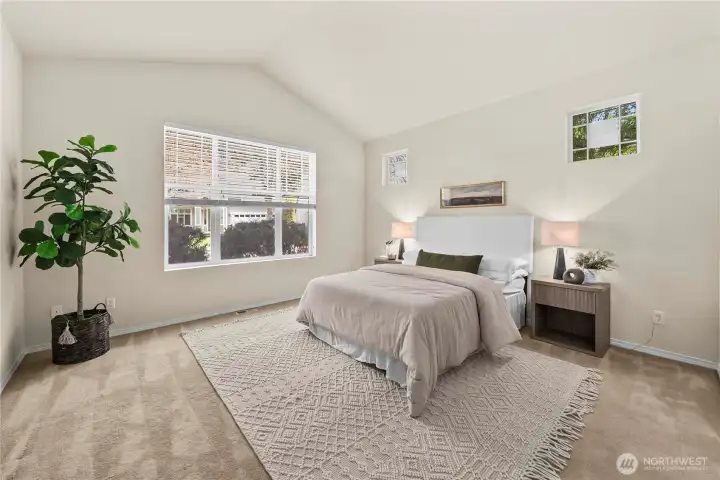 The primary bedroom features vaulted ceilings