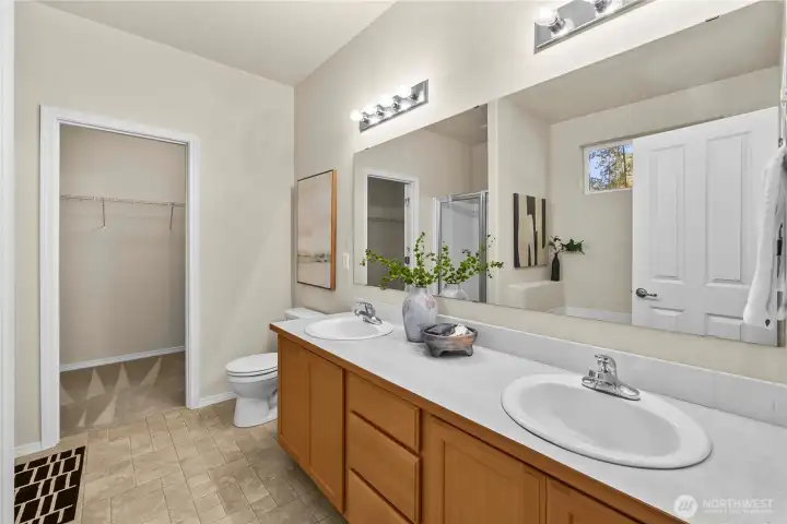 The primary bathroom is appointed with a dual-sink vanity and a seperate shower.