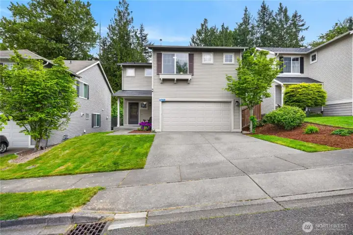 Charming Mount Vernon home with inviting curb appeal, mature landscaping, and a spacious two-car garage in a peaceful neighborhood setting.