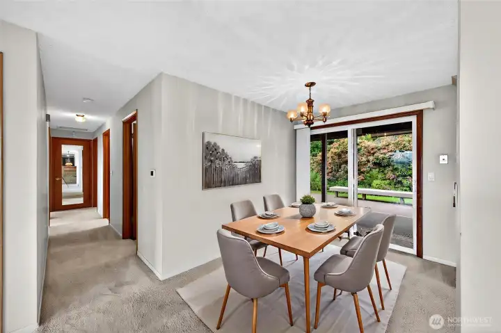 Dining Area Off The Kitchen . Slider leads to the outside with covered Patio & Lushes gardens .