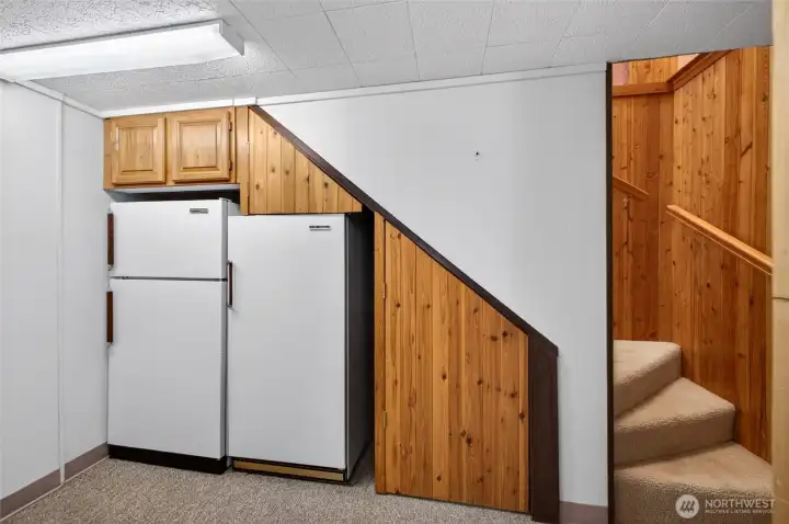 Stairs from the main level . On the lower level is a shop/utility room . And The Primary Suite with it's own 3/4 Bathroom .