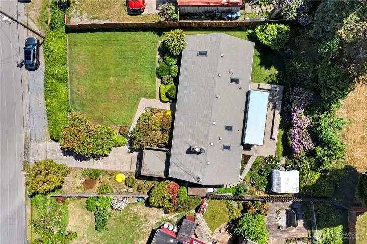 Ariel drone shot .Your Oasis Garden Setting with front & back sprinklers.  Roof is around 7 years old