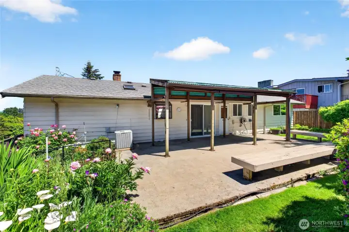 Large Back Patio with Covered BBQ Area and Built in Benches for Entertaining