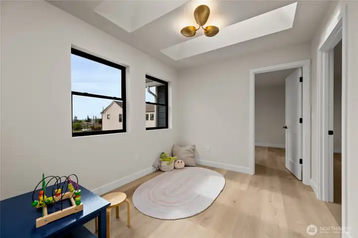 Upstairs bonus room outside of the bedrooms, with skylights