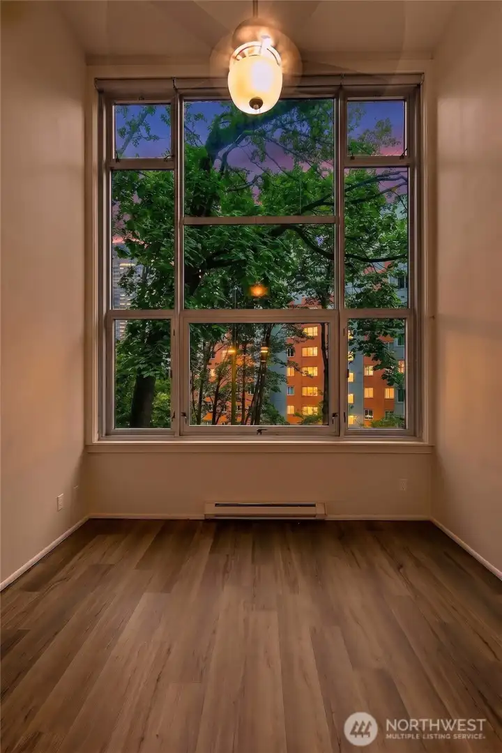 Dramatic window wall and filtered urban outlook
