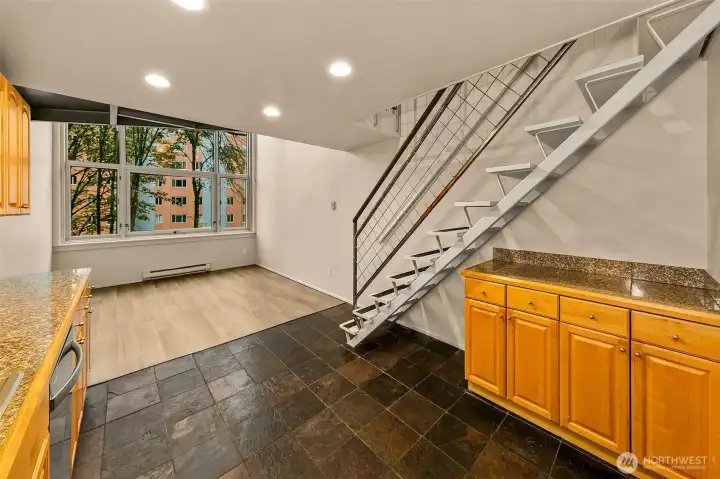 Steel stair and mezzanine loft anchor the space