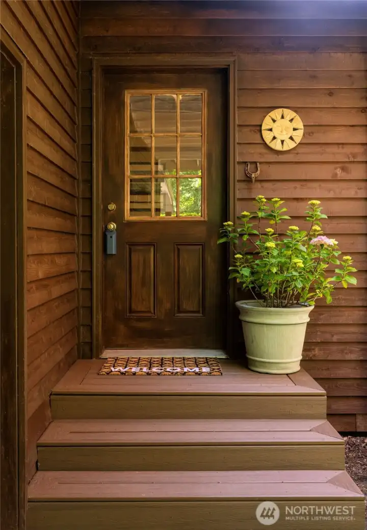 Welcoming entry framed by lush, mature, wooded greenery. Welcoming entry framed by lush, mature, wooded greenery.