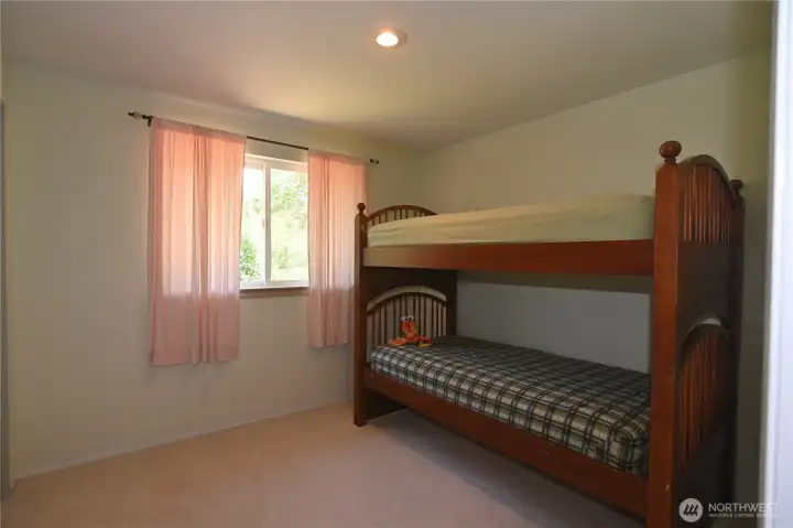 2nd main floor bedroom offers generous space & versatility, easily accommodating larger furnishings. Bunkbeds can stay. 2nd main floor bedroom offers generous space & versatility, easily accommodating larger furnishings. Bunkbeds can stay.