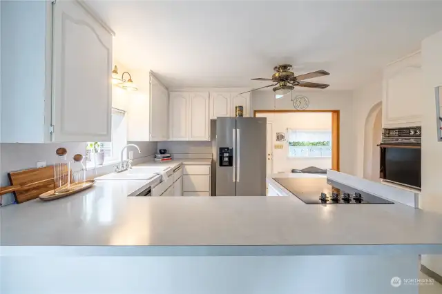 White painted cabinets with gray laminate countertops gives this kitchen an airy appearance. Refrigerator does not convey with home.