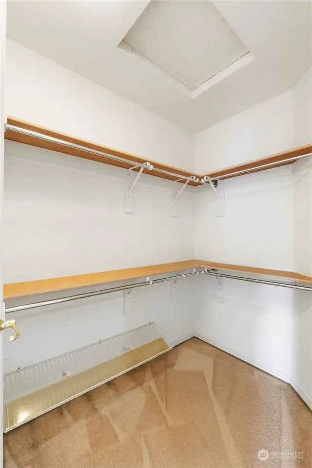 Primary walk-in-closet with shelves and racks all around