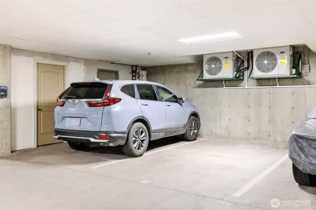Two secure parking spots with a storage room to the left.