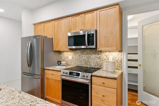 Kitchen with all new stainless steel appliances. Huge pantry to the right.