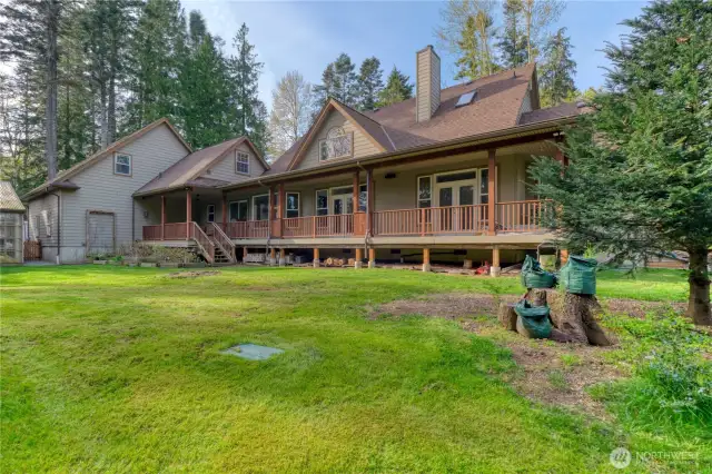 A stunning view of the back of the house and garage.