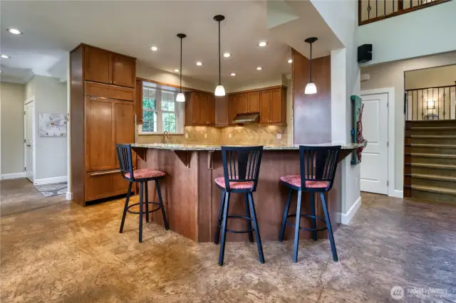 View of the Chef's kitchen with maple cabinetry, granite counters and Wolf Appliances.
